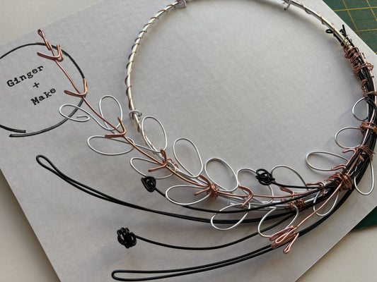 Wire wreath craft project on a white card with 'Ginger & Make' branding.