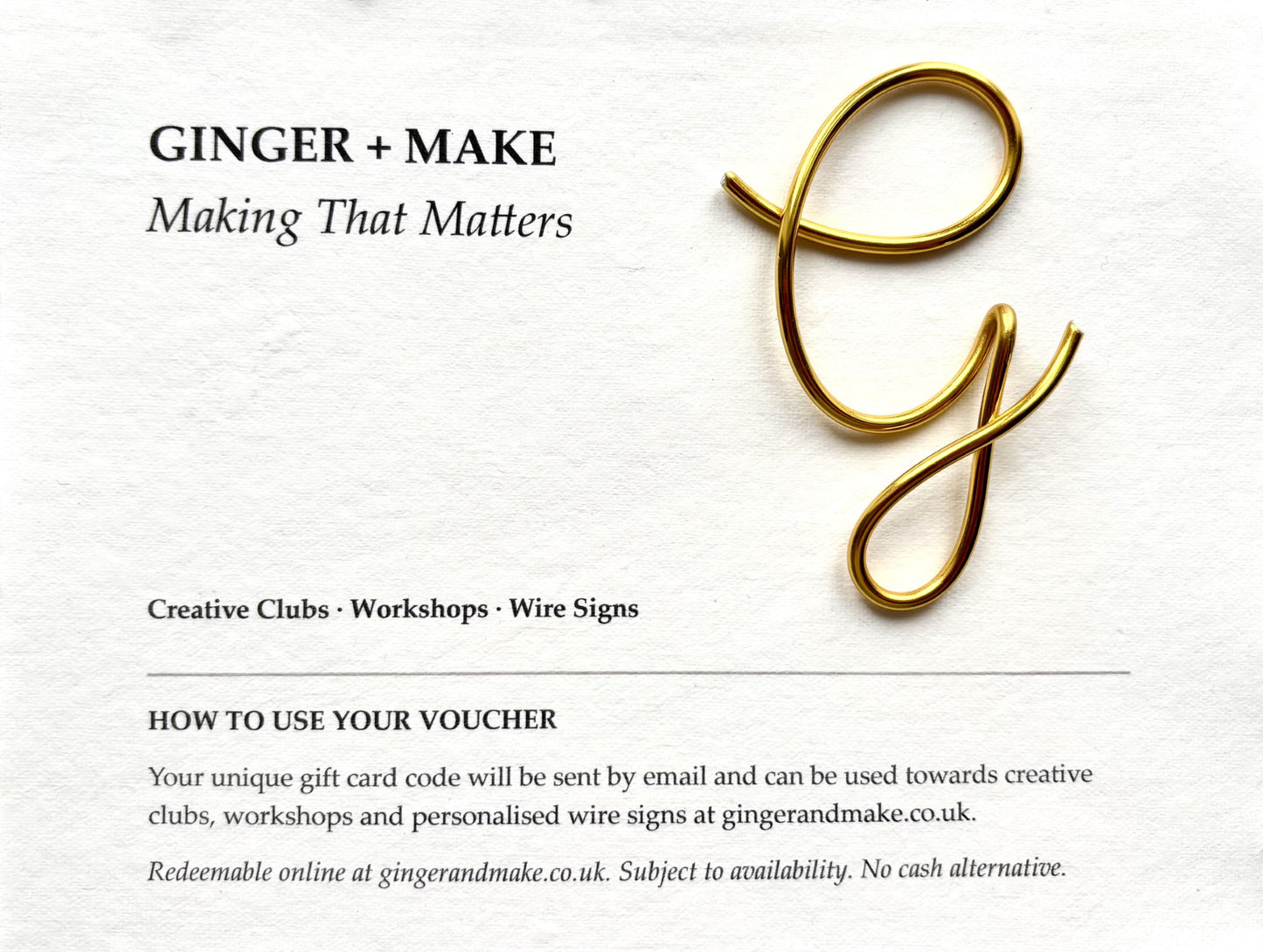 A gift voucher design for Ginger + Make, featuring a polished gold wire letter 'g' on a textured white paper background, with text detailing workshop and wire sign services.