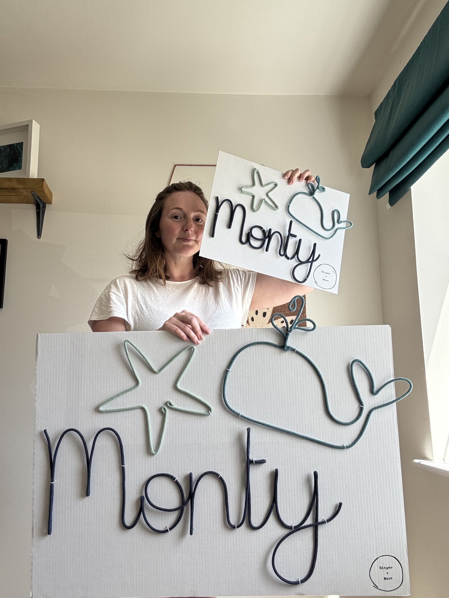 Jenni from Ginger + Make holding wire signs with 'Monty' and starfish and whale figures. One in standard size and one in XL. 
