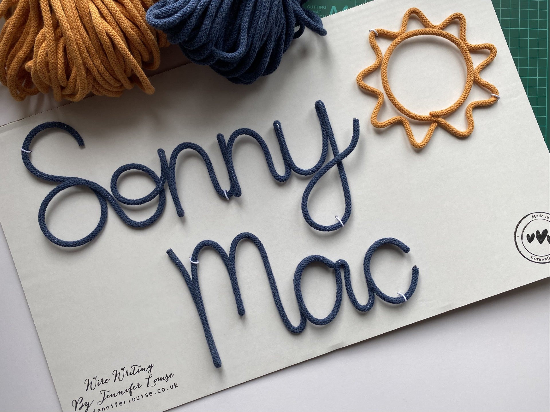 Cotton cord with 'Sonny Mac' in wire on a white surface