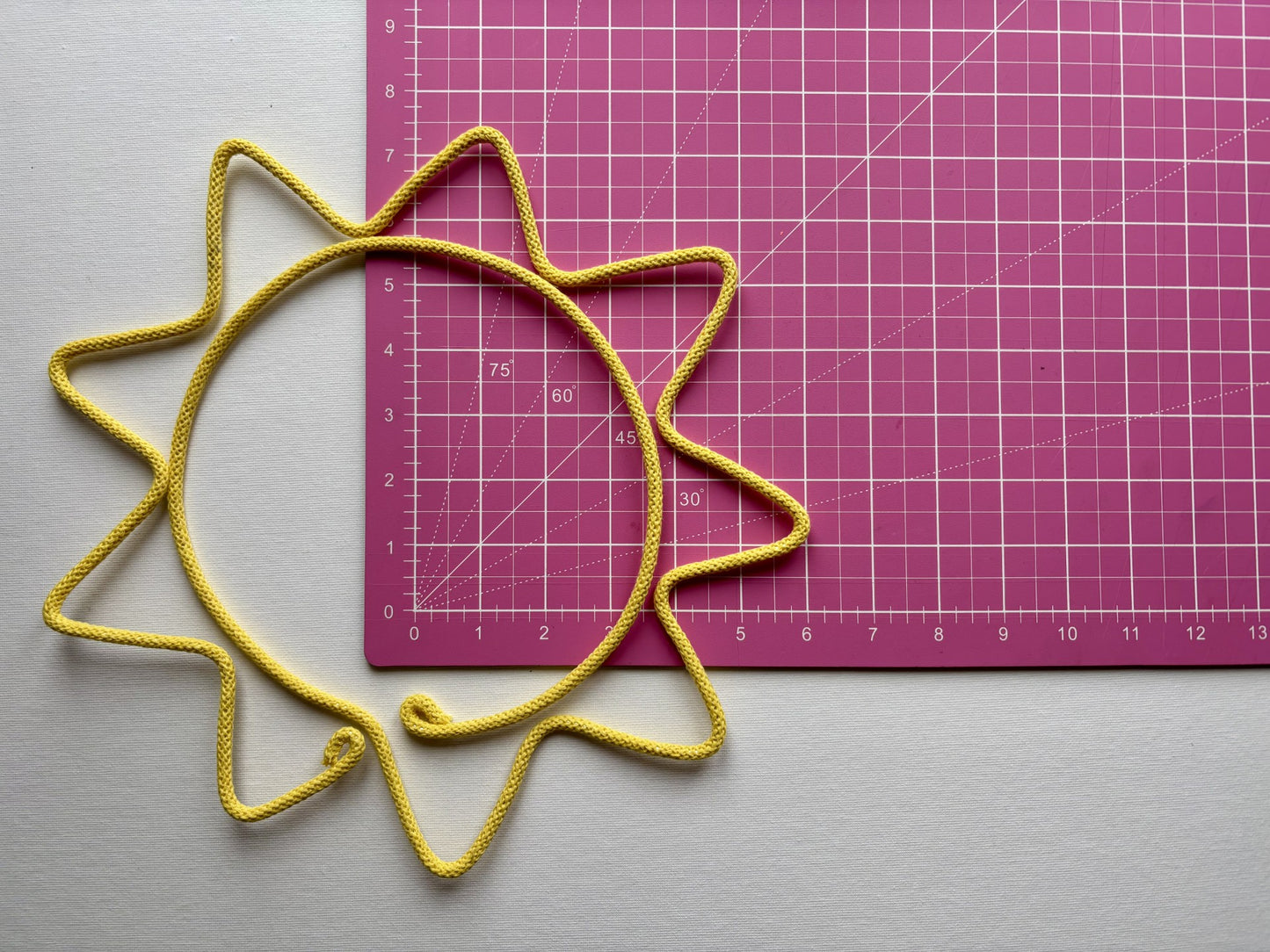 Extra large wire yellow sun on pink cutting mat